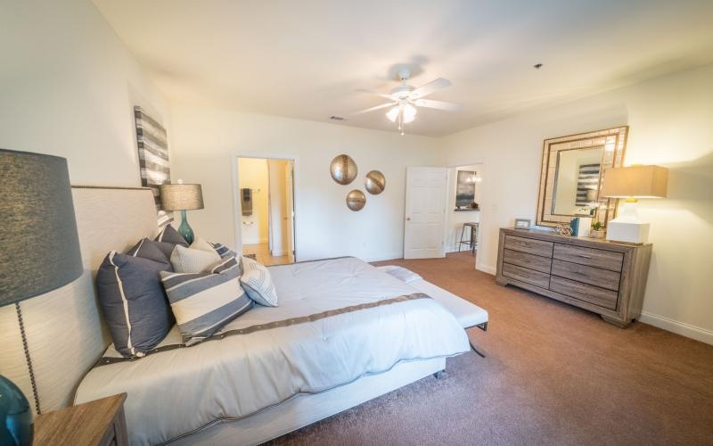 a bedroom with a bed and lamps