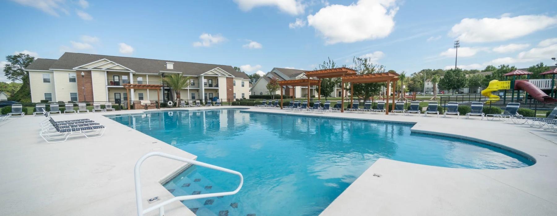 a swimming pool with a building in the background