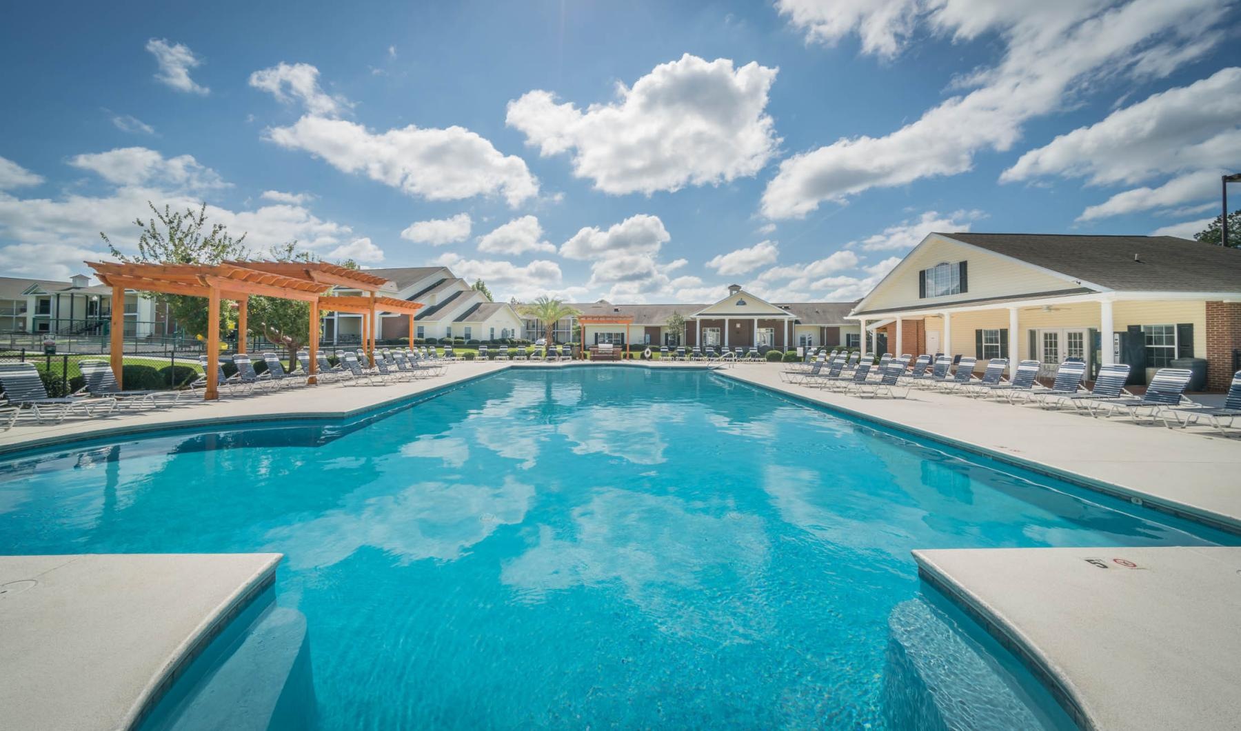 a swimming pool with chairs around it